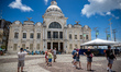 Tourists walk in front of the Rio Branco Palace in Salvador, Bahia, Brazil, on February 8,...