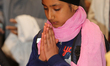 A Sikh girl offers prayers at a gurdwara (Sikh Temple) during Vaisakhi in Toronto, Ontario...
