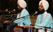 Sikh men sing kirtans (religious songs) at a gurdwara (Sikh Temple) during Vaisakhi in Tor...