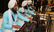 Sikh men sing kirtans (religious songs) at a gurdwara (Sikh Temple) during Vaisakhi in Tor...