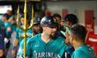 Cal Raleigh of the Seattle Mariners is congratulated in the dugout after hitting a two-run...