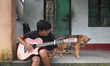 A local boy sings in front of a house in Sittong, Darjeeling, West Bengal, India, on Augus...