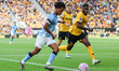 Manchester City's Oscar Bobb races forward chased by Wolverhampton Wanderers' Marshall Mun...