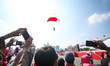 Indonesian Armed Forces soldiers perform a parachute jump at Indonesia's 80th Independence...