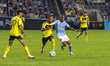 Hany Mukhtar (#10) of Nashville SC is challenged by Andres Perea (#8) of New York City FC...