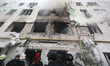 The aftermath of a Russian drone strike on a multi-story residential building occurs in Kh...