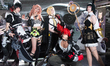 Cosplayers pose for pictures at the Cologne Trade Fair Center during the opening day of Ga...