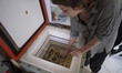 Melina Pourmanesh, 24, a member of Generation Z, places pottery in a home pottery kiln in...