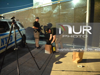 Members of the NYPD Crime Scene Unit work at the scene where a 46-year-old man identified as James Gaines is fatally shot in the neck at the... by Kyle Mazza/NurPhoto