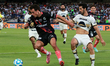 Pablo Bennevendo #2 of Pumas and Esteban Lozano #17 of Puebla fight for the ball during th...
