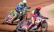 Dan Bewley of Belle Vue Aces in red leads Leon Flint of Sheffield Tigers in yellow and Chr...