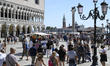 Tourists visit St. Mark's Square (Piazza San Marco) in Venice, Italy, on August 25, 2025. 