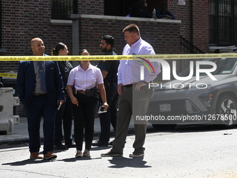 Members of the NYPD Crime Scene Unit and detective squad work at the scene after a man is fatally shot in the back in broad daylight in the... by Kyle Mazza/NurPhoto