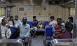 A man carries an idol of the Hindu god Ganesha on a suburban train ahead of the Ganesh Cha...
