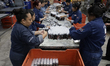 Women work in the plastic container assembly area inside the El Oso shoe polish factory, l...