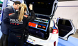 A woman agent of the Mossos d'Esquadra shows a police car from the Catalan police Mossos d...