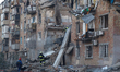 Rescuers conduct a search and rescue mission at a five-storey residential building in the...
