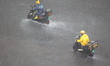 The courier rides in the rainstorm in Qingdao West Coast New Area, Shandong Province, Chin...
