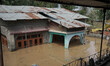 Residential structures are submerged in water after the River Jehlum breaches at many plac...