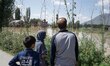 People watch as the floodwater from the River Jehlum enters the residential areas in the Z...