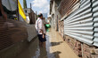 People recover their belongings from a submerged neighborhood after the River Jehlum breac...
