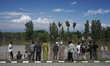 People watch as the floodwater from the River Jehlum enters the residential areas in the Z...