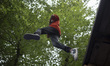 A young Iranian boy jumps as he plays at GMAX Adrenaline Park in the Namakabrud township i...