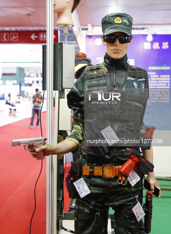 A visitor tries a holster at Chinese Defense Information Equipment & Technology Exhibition 2016 (CNTE2016) in Beijing, capital of China, Jun...