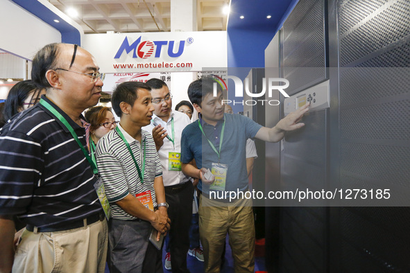 A company representative shows a Uninterruptible Power System (UPS) product at Chinese Defense Information Equipment & Technology Exhibition...
