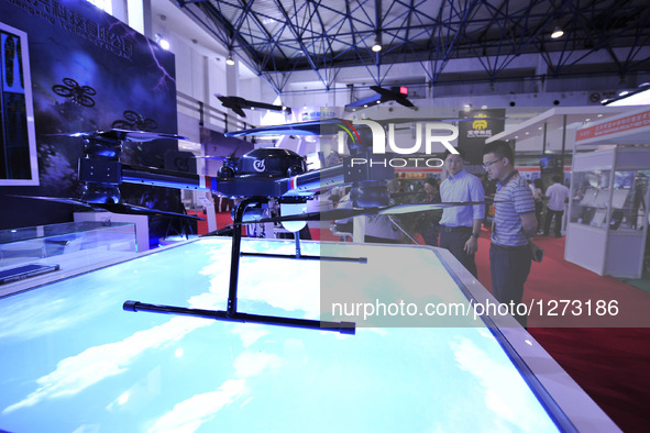 Visitors view a drone at Chinese Defense Information Equipment & Technology Exhibition 2016 (CNTE2016) in Beijing, capital of China, June 15...