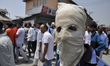 A Kashmiri Masked protester Poses for a picture during the funeral of  Tanveer sultan  in...