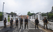 Nepal Army personnel stand guard in front of the vandalized Presidential residence in Kath...