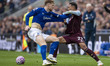 Morgan Rogers #27 of Aston Villa F.C. challenges Jake O'Brien #15 of Everton F.C. during t...