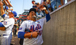 Former New York Mets player Johan Santana (57) acknowledges fans as he leaves the field af...