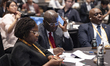 Participants listen to presentations during the side event "Open Source Day" at the Grand...