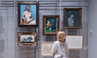 LONDON, UNITED KINGDOM - SEPTEMBER 15, 2025: A gallery staff member looks at artworks by P...