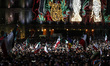 People lift Mexican flags during the Grito de Independencia for the 215th anniversary of t...