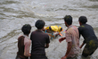 Nepali Hindu devotees immerse the idol of Lord Bishwokarma, the god of architecture, in th...