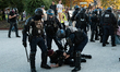 A police officer detains a protestor in Paris, France, on September 18, 2025, during a day...