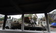 Officials lift a burnt vehicle using a crane from the premises of Singhadurbar, the admini...