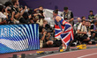 Amy Hunt of Great Britain poses for photographers with a Union flag after winning the silv...