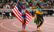 Melissa Jefferson-Wooden of the USA celebrates with a Stars & Stripes after winning gold i...