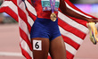 Melissa Jefferson-Wooden of the USA celebrates with a Stars & Stripes after winning gold i...