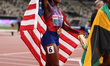 Melissa Jefferson-Wooden of the USA celebrates with a Stars & Stripes after winning gold i...