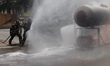 Firefighters extinguish a fire during the second national earthquake drill with a magnitud...