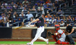 New York Mets player Pete Alonso singles during the first inning of a baseball game agains...