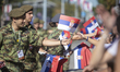 The distribution of Serbian flags occurs before the ''Power of Unity'' military parade in...