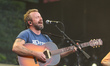 Dave Simonett of Trampled by Turtles performs during the Farm Aid 40 Music Festival in Min...