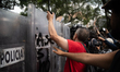 Demonstrators confront riot police during a rally near the Israeli Embassy in Mexico City,...