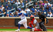 New York Mets player Luis Torrens (13) doubles during the third inning of a baseball game...